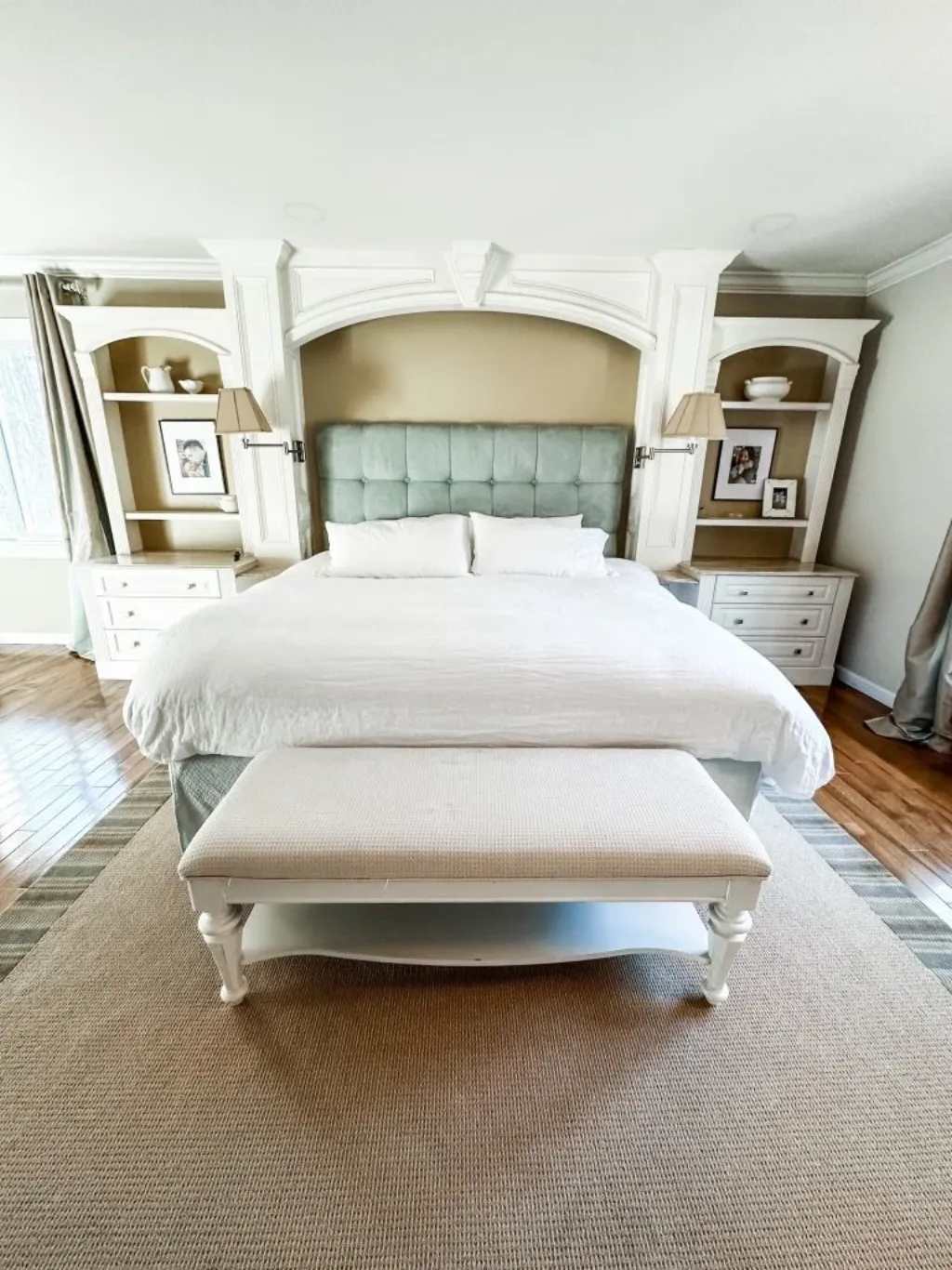 A neatly made bed with white linens