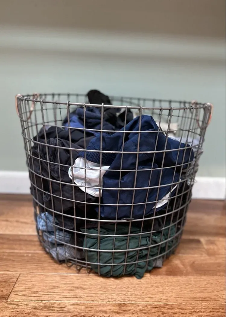 Laundry gathered in a wire hamper