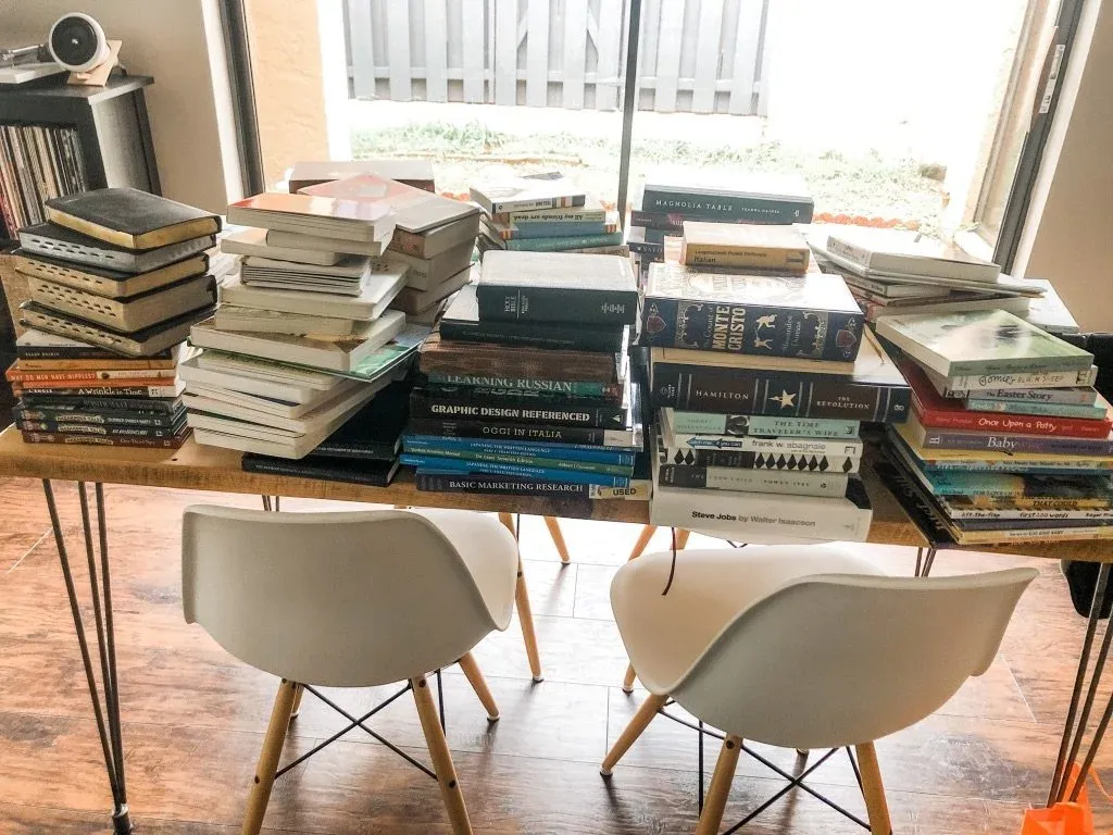 Every book in the house piled together on a table