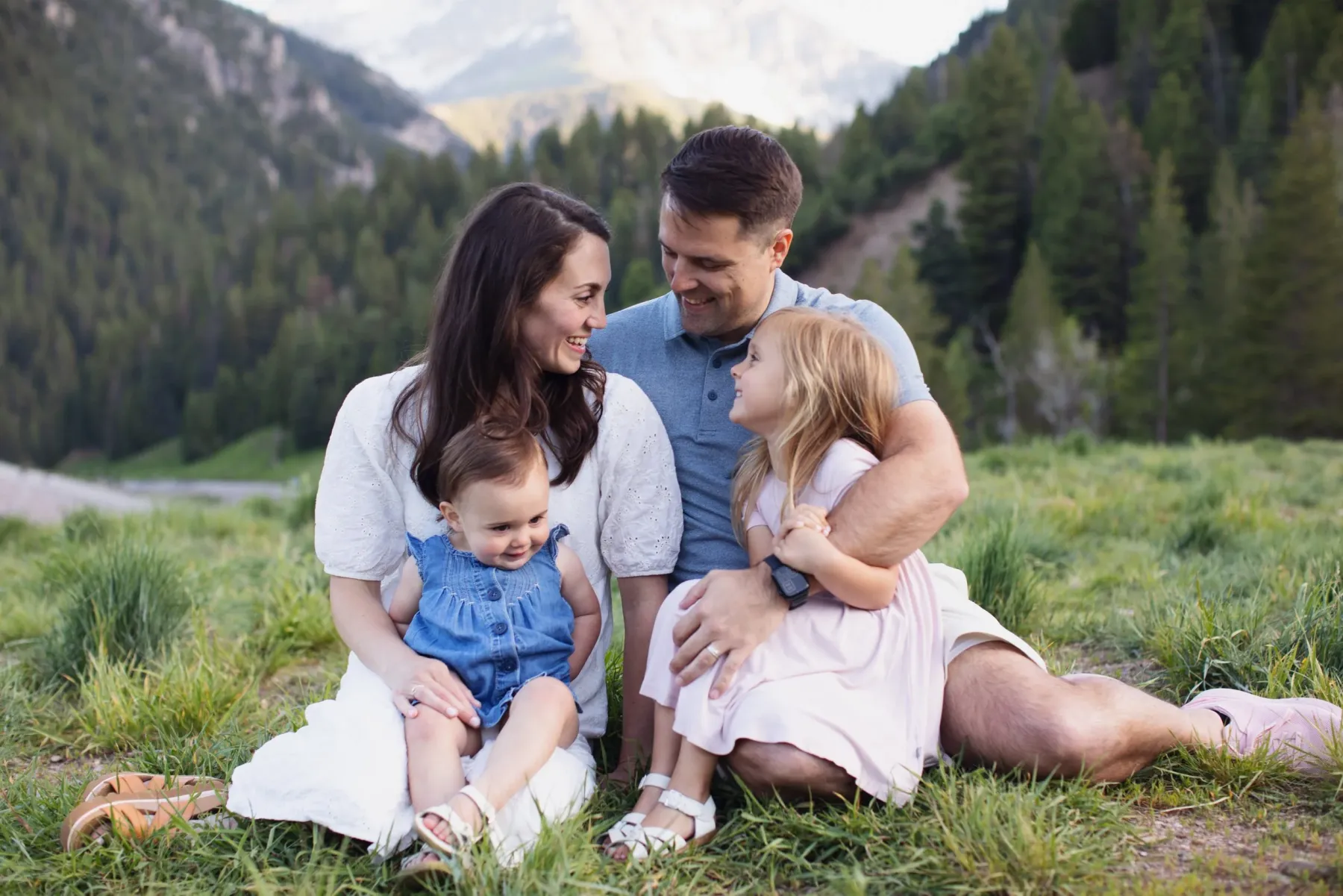 Meg with her husband and their two daughters in a mountain meadow