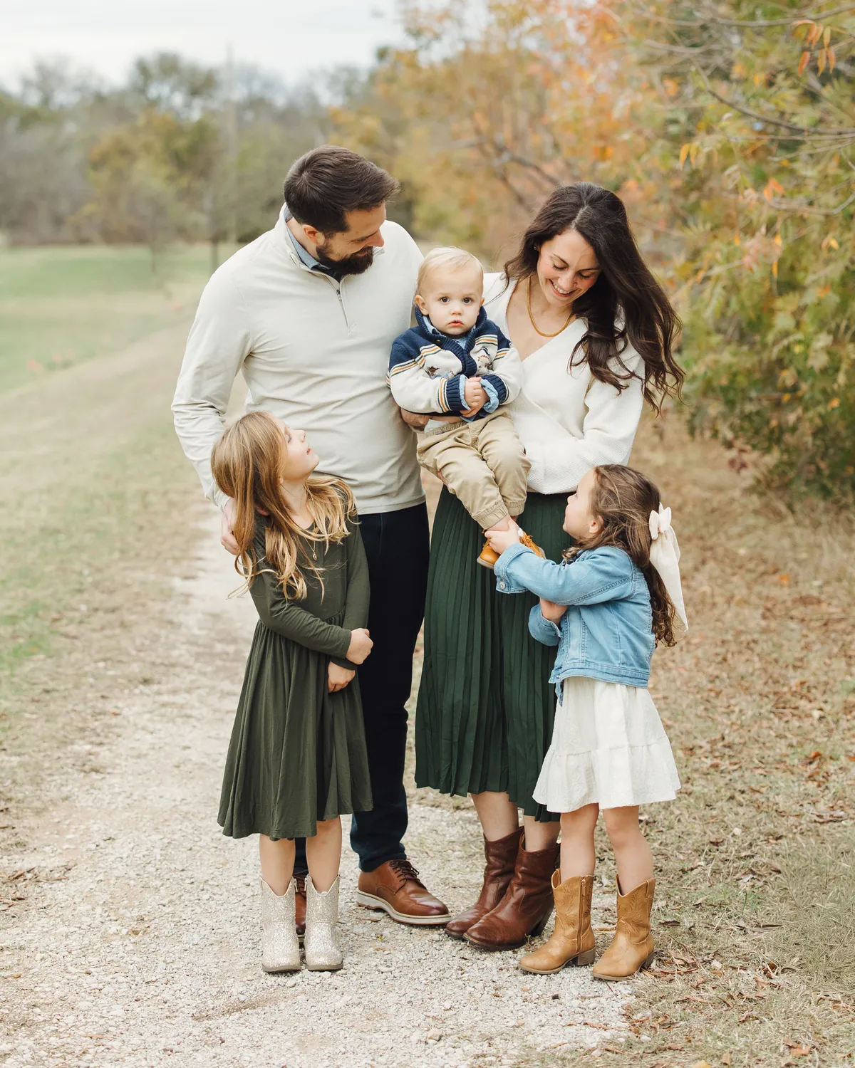 Meg and her husband with their two daughters and their little son, on a path in autumn