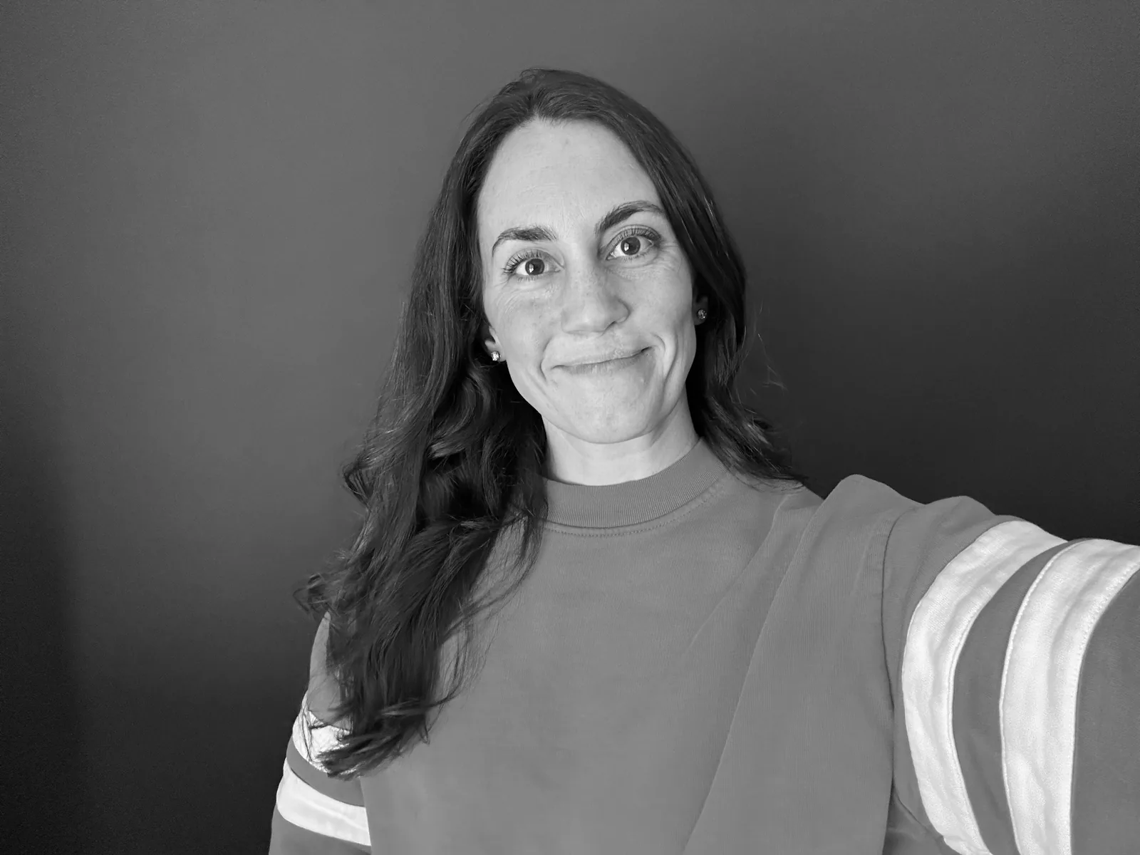 Meg, smiling, in black and white
