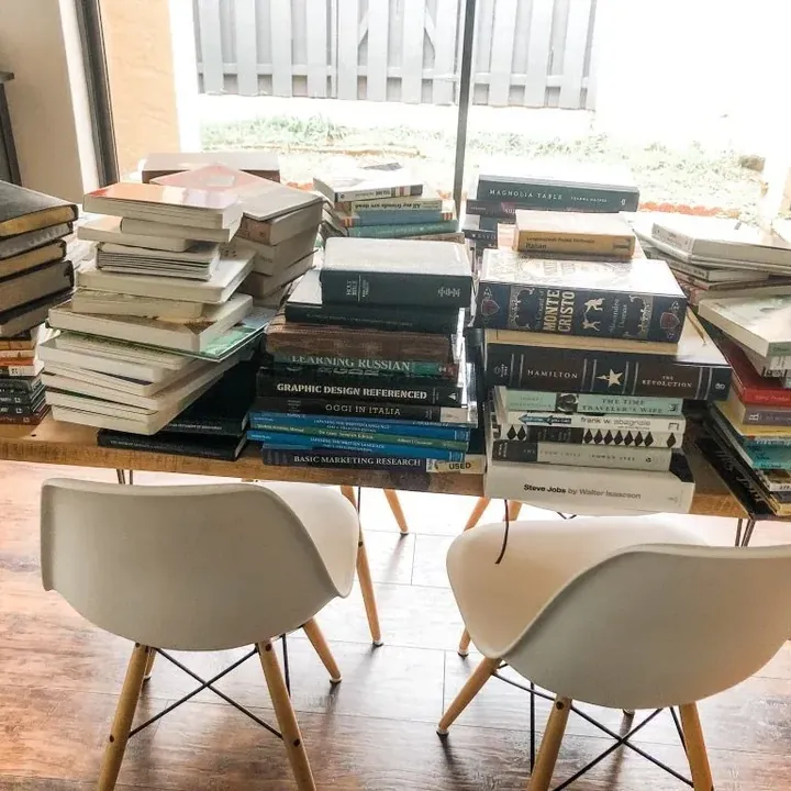Every book in the house piled together on a table