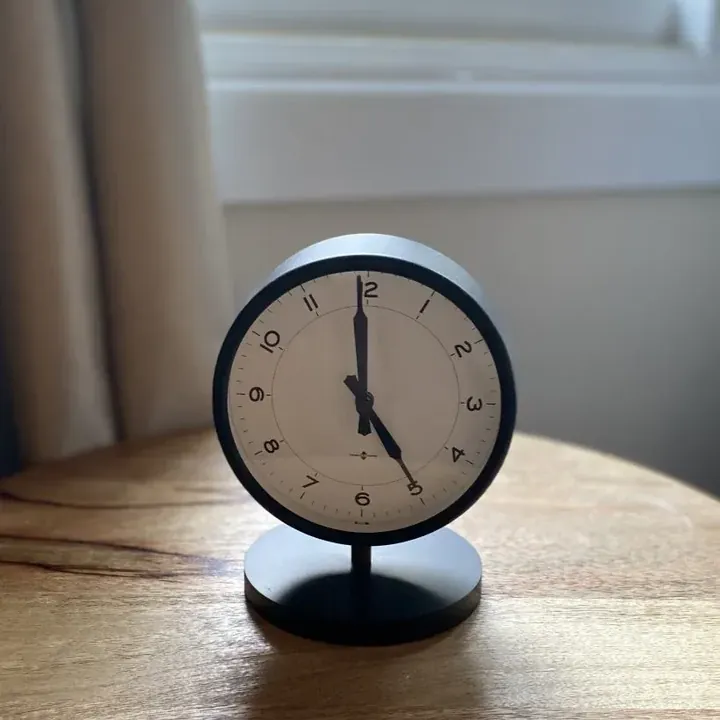 A small alarm clock on a wooden table