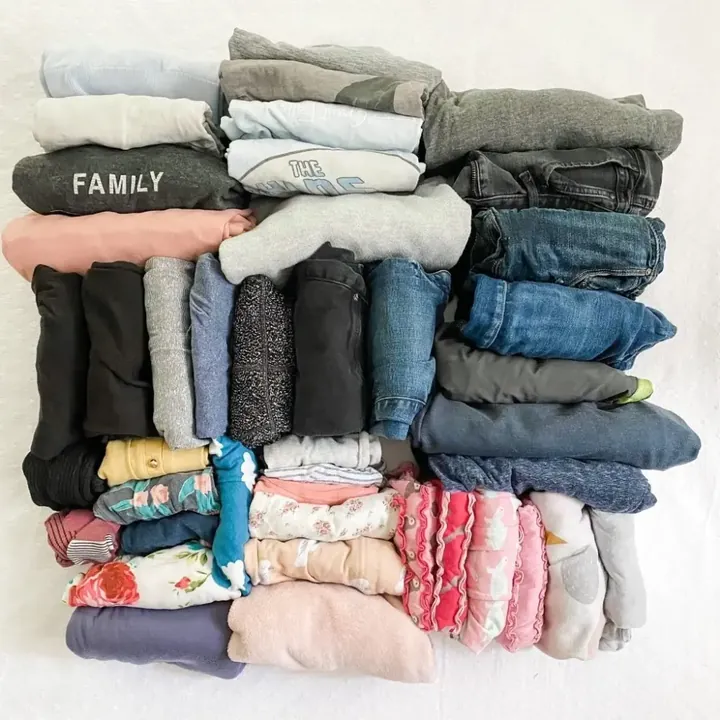 Clothes folded into neat stacks by type