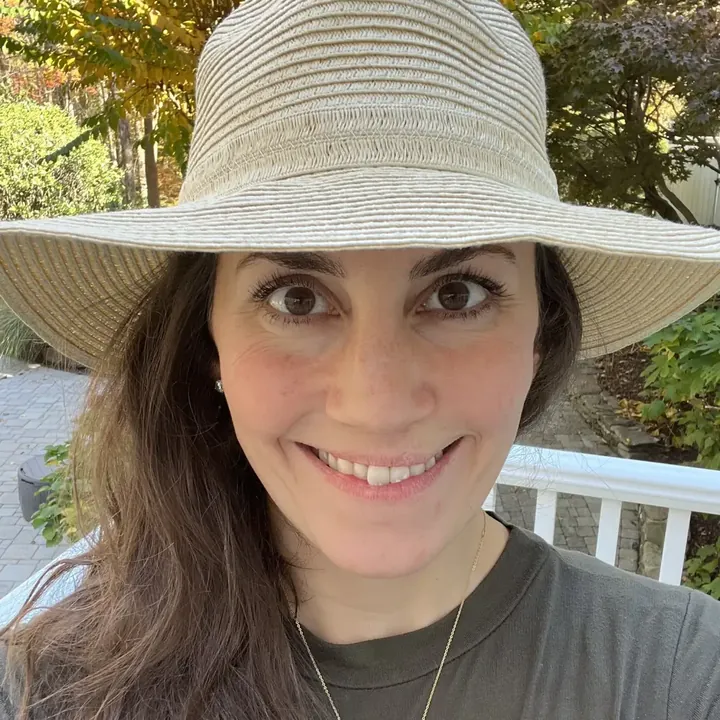 Meg in her sun hat, smiling